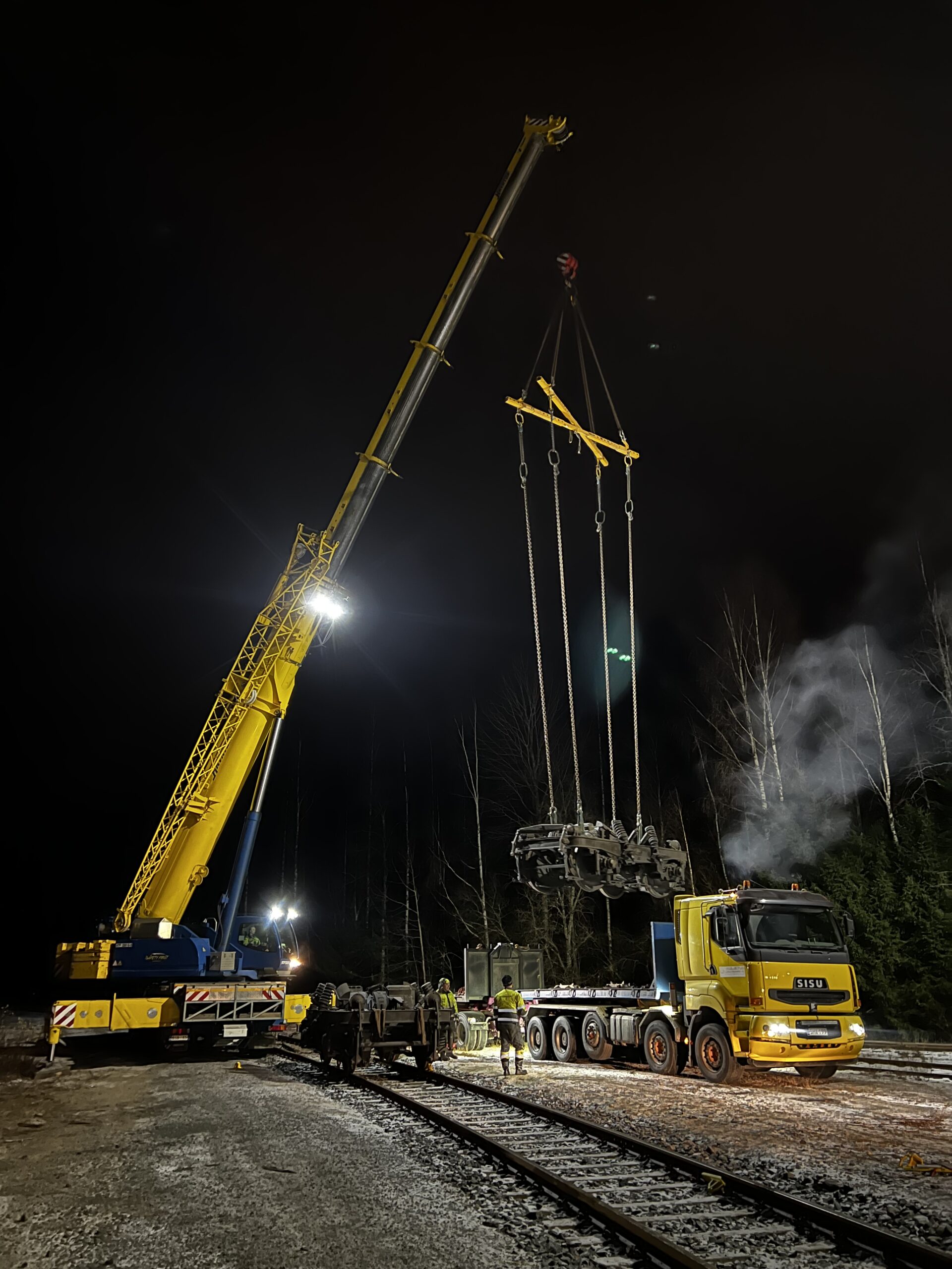 man and woman laughing while sitting in front of laptops