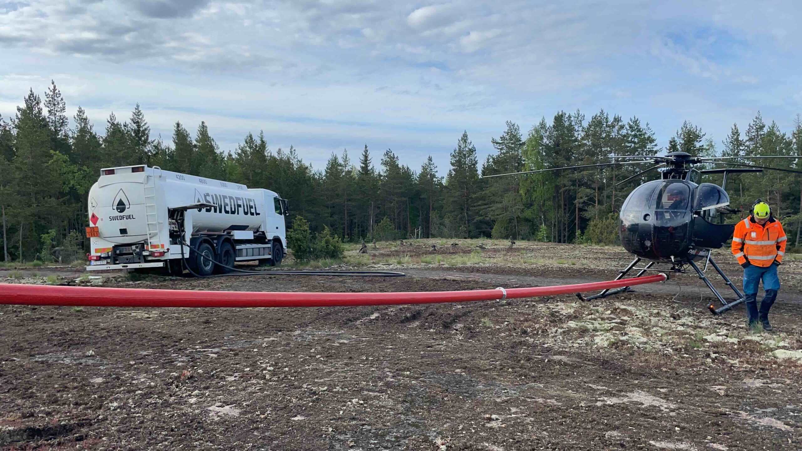 man and woman laughing while sitting in front of laptops